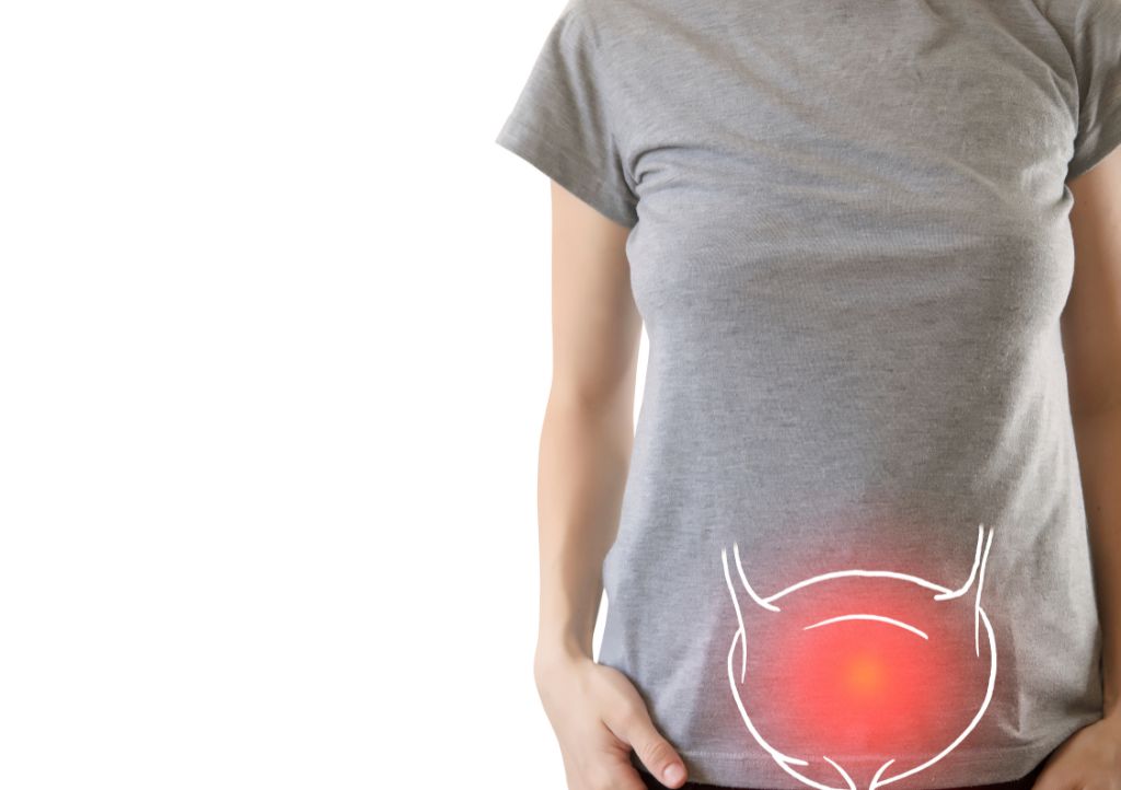 woman with bladder issues a person with their hand over their bladder, experiencing bladder pain